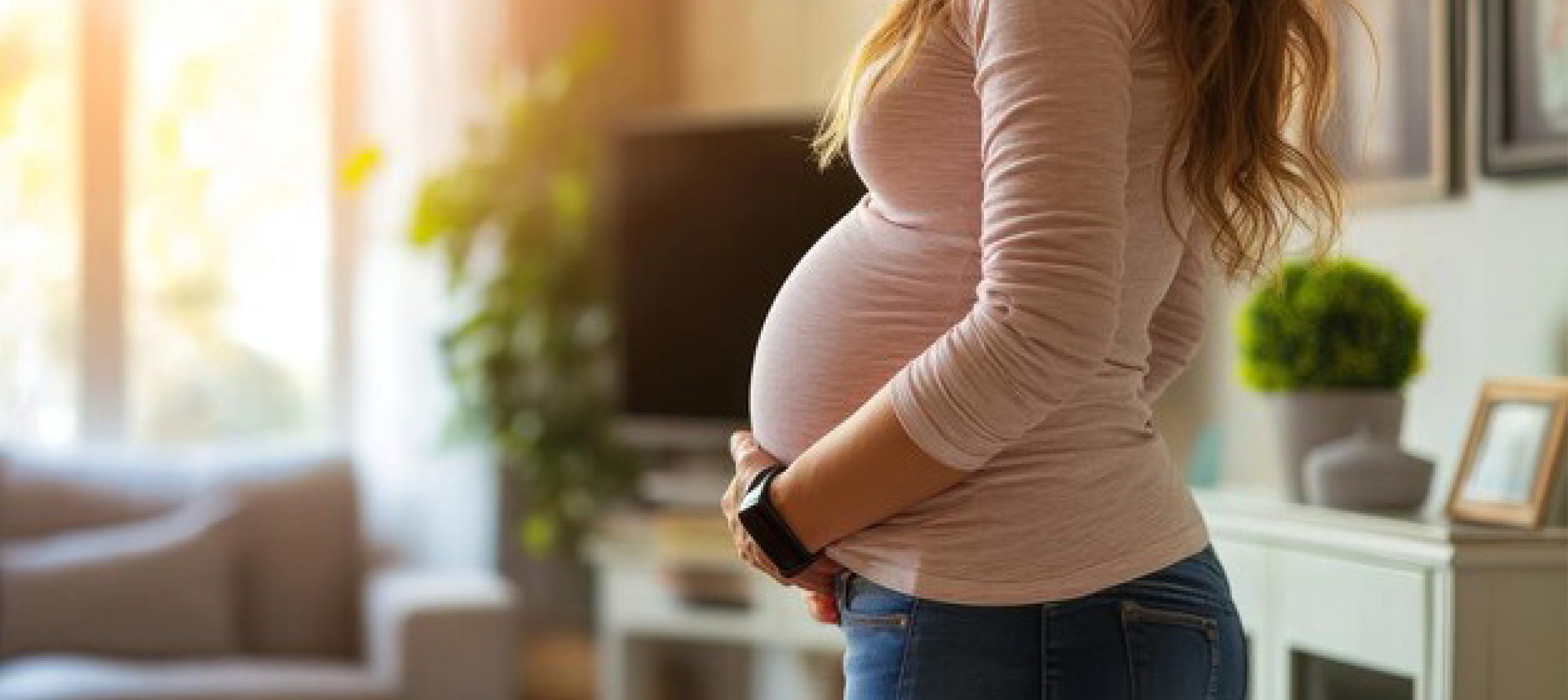 a little girl is hugging her mother's pregant stomach